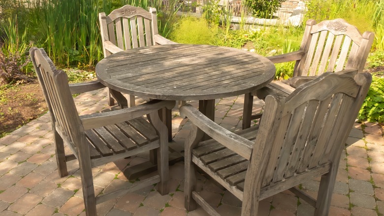 man upcycling wooden patio table