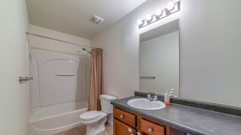 Outdated bathroom with vanity lights