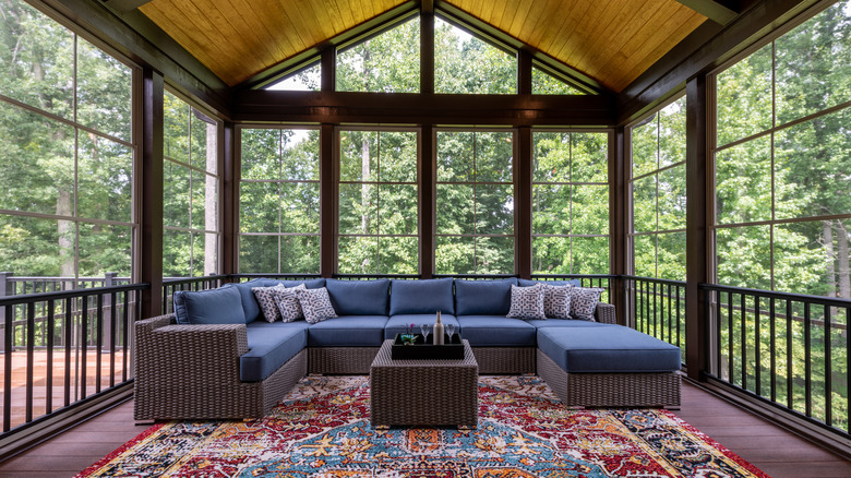 Screened-in porch with sofa