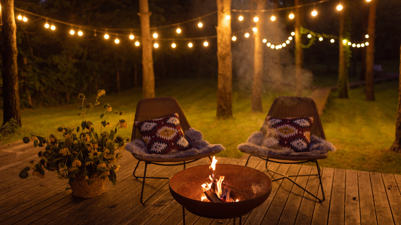 backyard chairs firepit fairy lights
