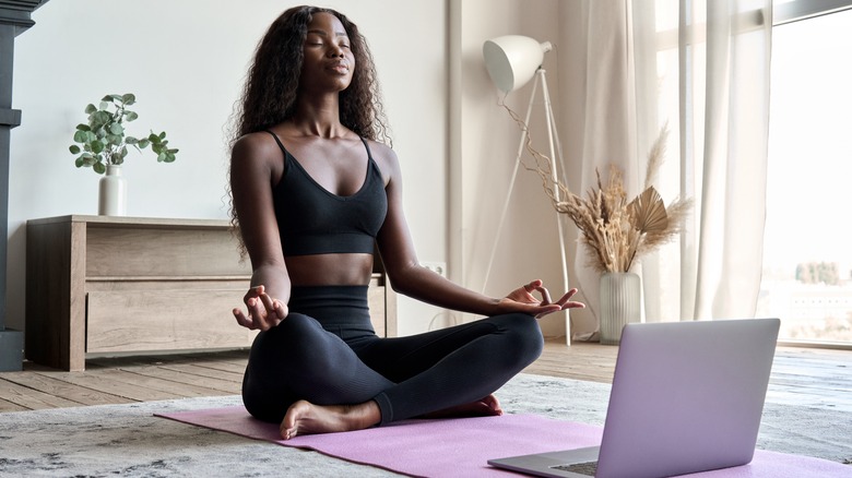 woman meditating workout clothes