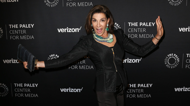 Hilary Farr smiling with arms out