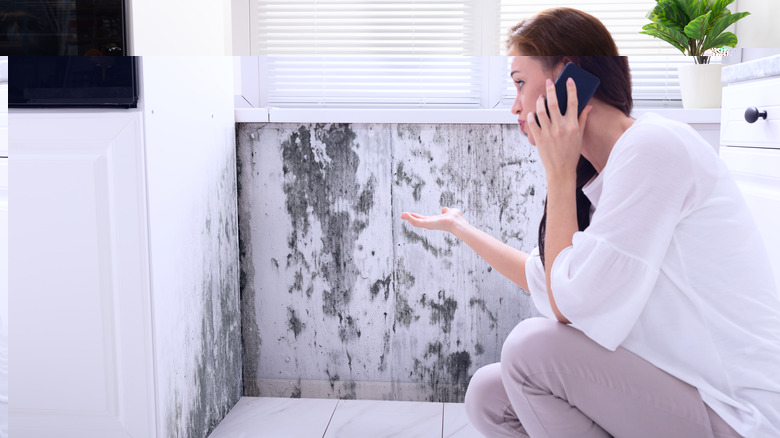 woman finding mold in bathroom