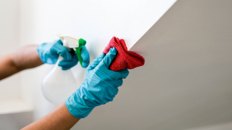 Person cleaning wall edges with fabric softener